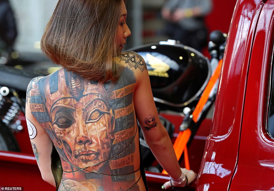 The three-day event is being held in a former industrial site, now named Tour & Taxis, in the heart of Belgium's capital city. Pictured: One woman shows off her full-back, colour tattoo of an Egyptian pharaoh