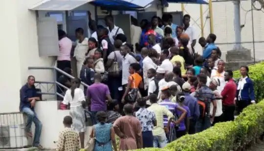 VIDEO: Bank Workers Escape Through Fence As Angry Youths Vandalize First Bank Over Naira Scarcity