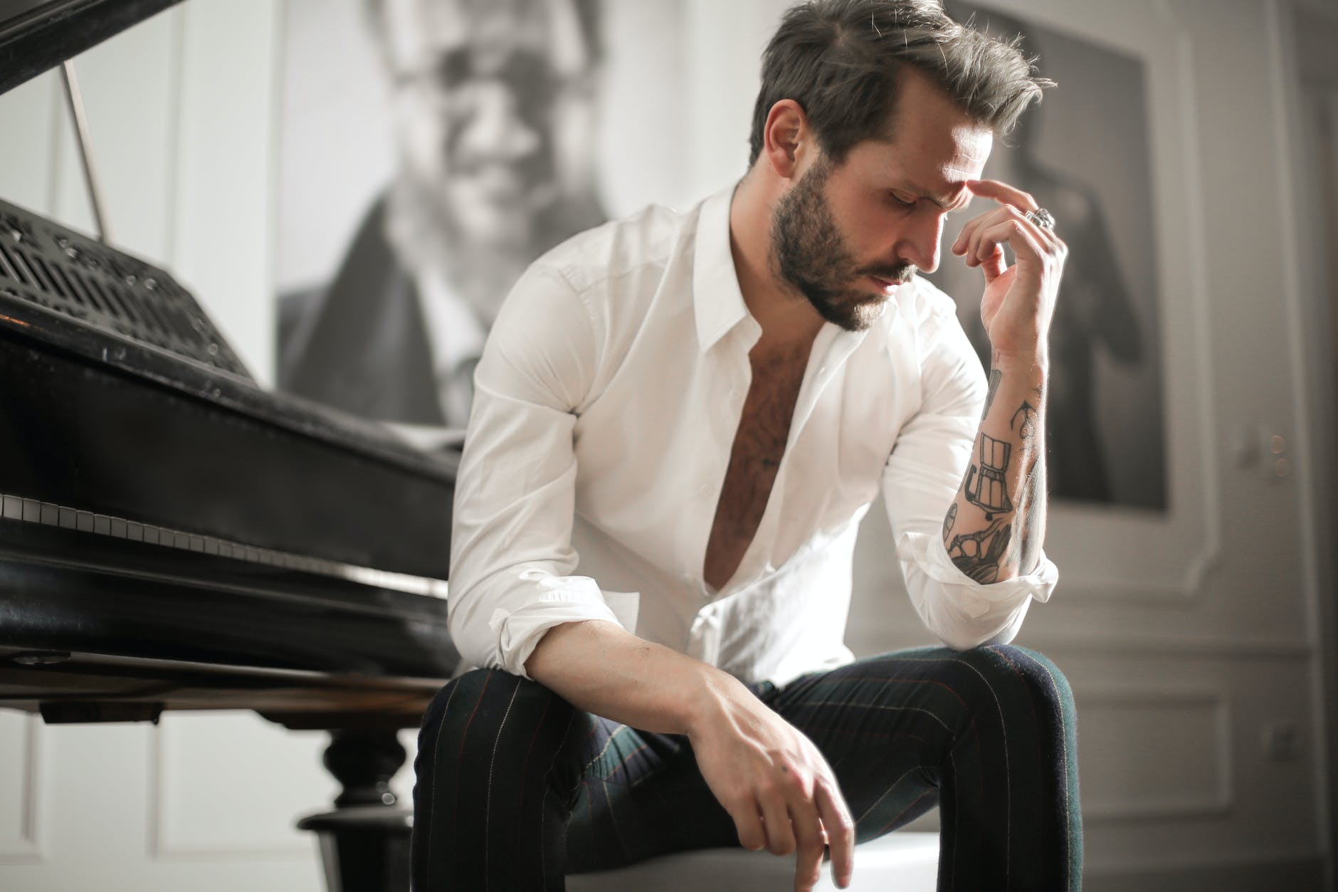dramatic tattooed male sitting at piano 20 Unspoken Rules and Success Pills for Men