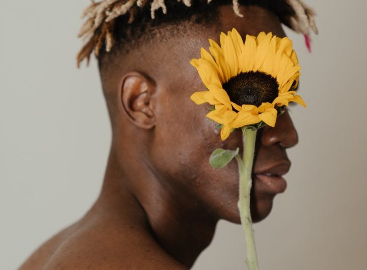 man with sunflower on his head