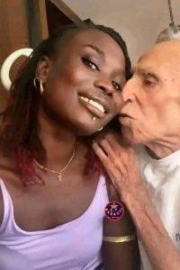 ‘God When’ – Single Women React as Lady Flaunts Her 80-year-old American Husband Online